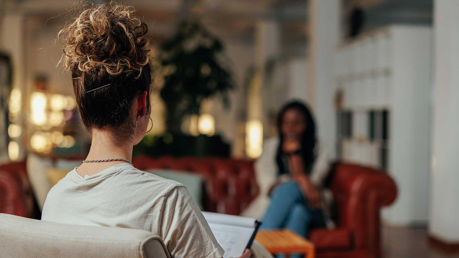 Psychologist with notepad meeting with a patient representing psychology program at Clarkson university 